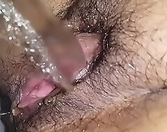 Hairy pussy babe taking a piss closeup