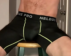 Stretching with workout shorts and massage balls on stool